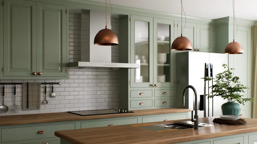 A cozy kitchen with green cabinets, a wooden countertop, and copper pendant lights.