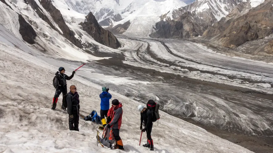 group of hikers walking on snow and ice terrain