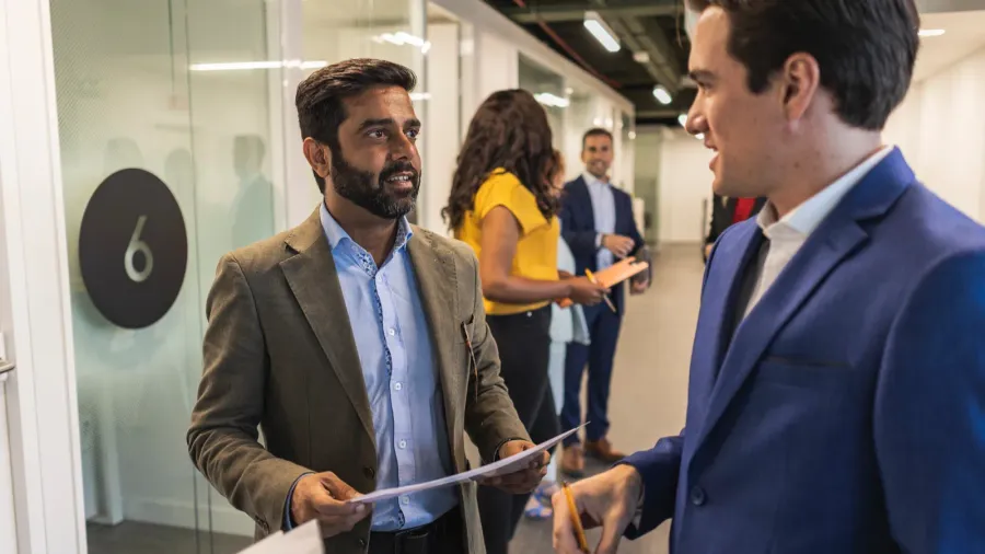 group of multiracial business professionals having a conversation in an