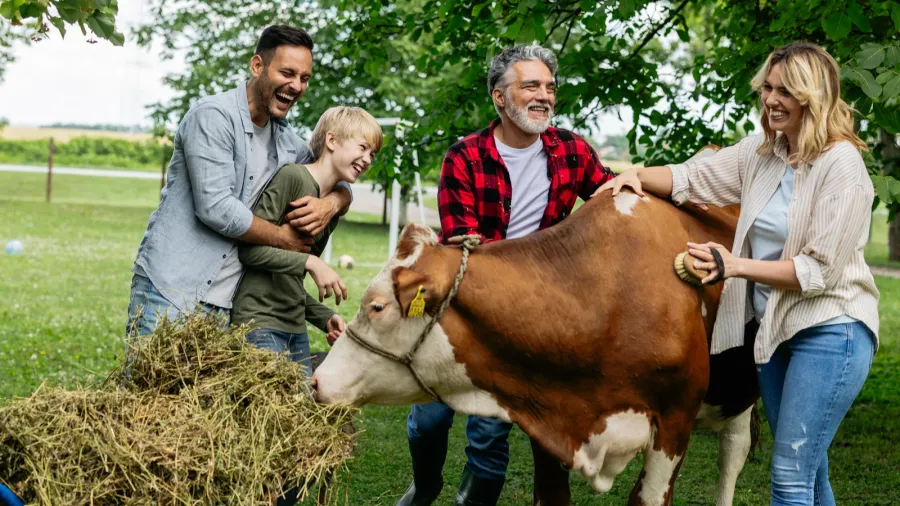 happy multi generational family interacting with a brown and white