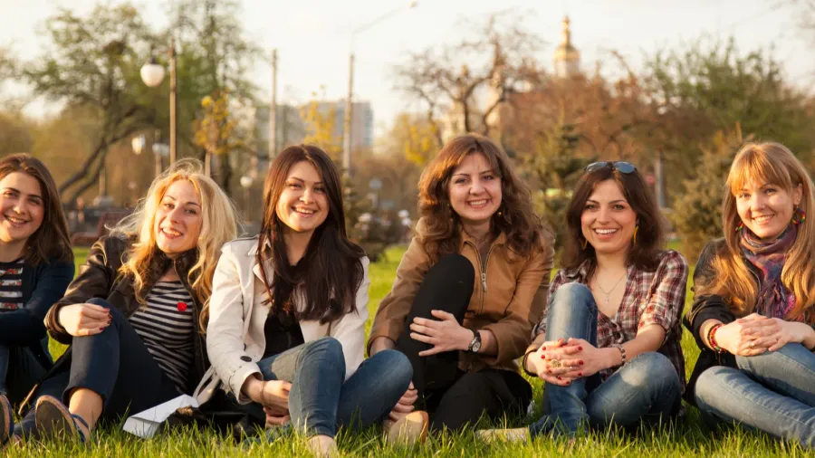 happy smiling group sitting on the grass