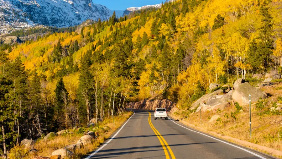 highway at autumn sunny day in rocky mountain national park