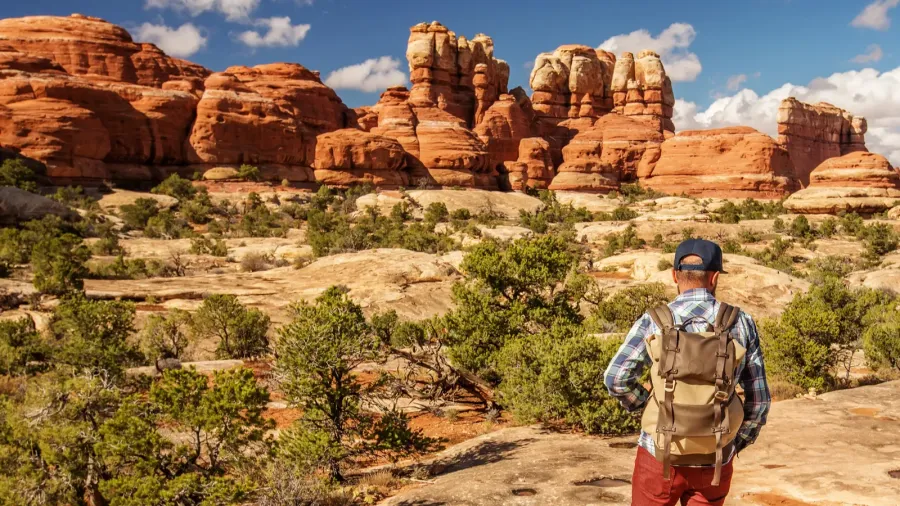 hiker in canyonlands national park needles in the sky in