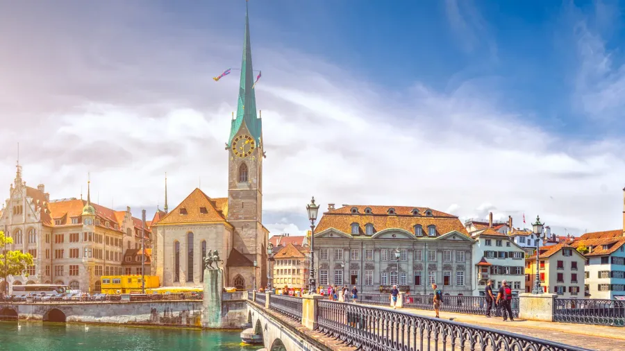 historic fraumunster church and swans on river limmat zurich switzerland
