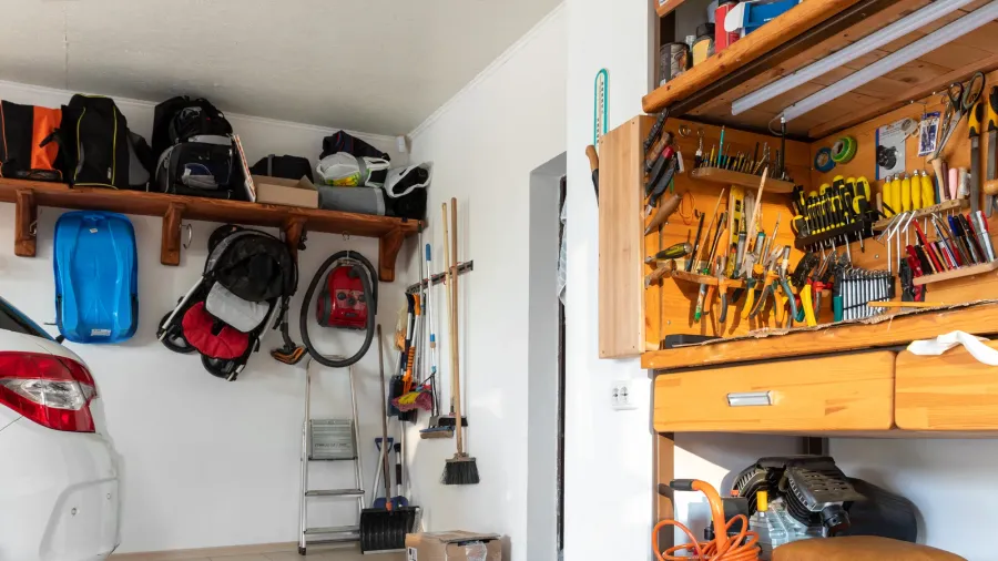 home suburban car garage interior with wooden shelf tools equipment