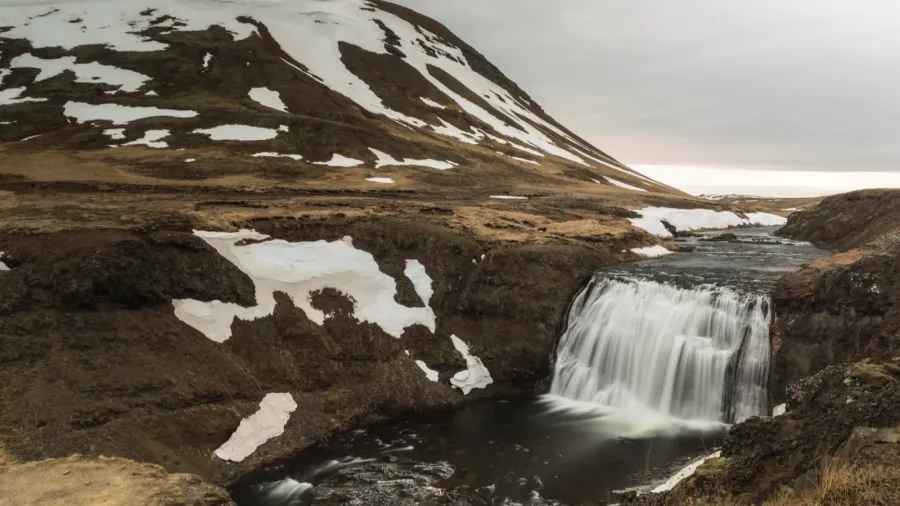 iceland landscape with waterfall in winter