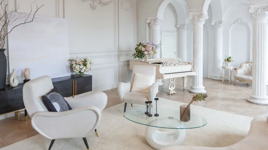 Rich luxurious interior of a cozy room with modern stylish furniture and grand piano, decorated with baroque columns and stucco on the walls.