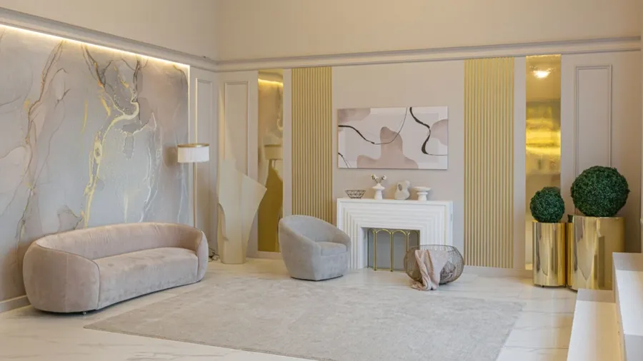 An ultra modern elegant interior of a cozy studio in soft pastel colors with comfy sofas, art work, and plants.