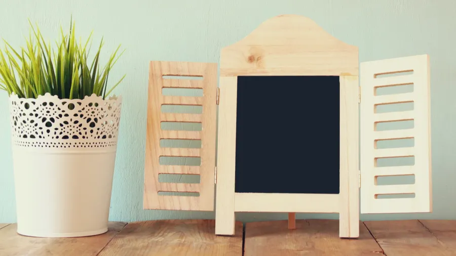 image of vintage wooden classical frame on wooden table filtered