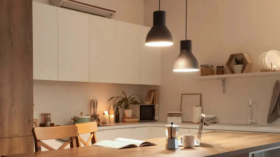 interior of kitchen with table counters and glowing lamps in