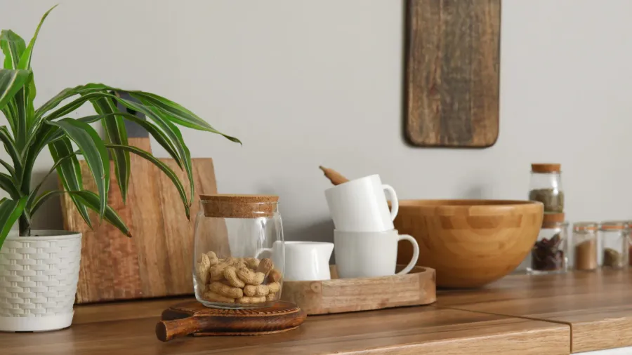 interior of light kitchen with utensils on white counters closeup