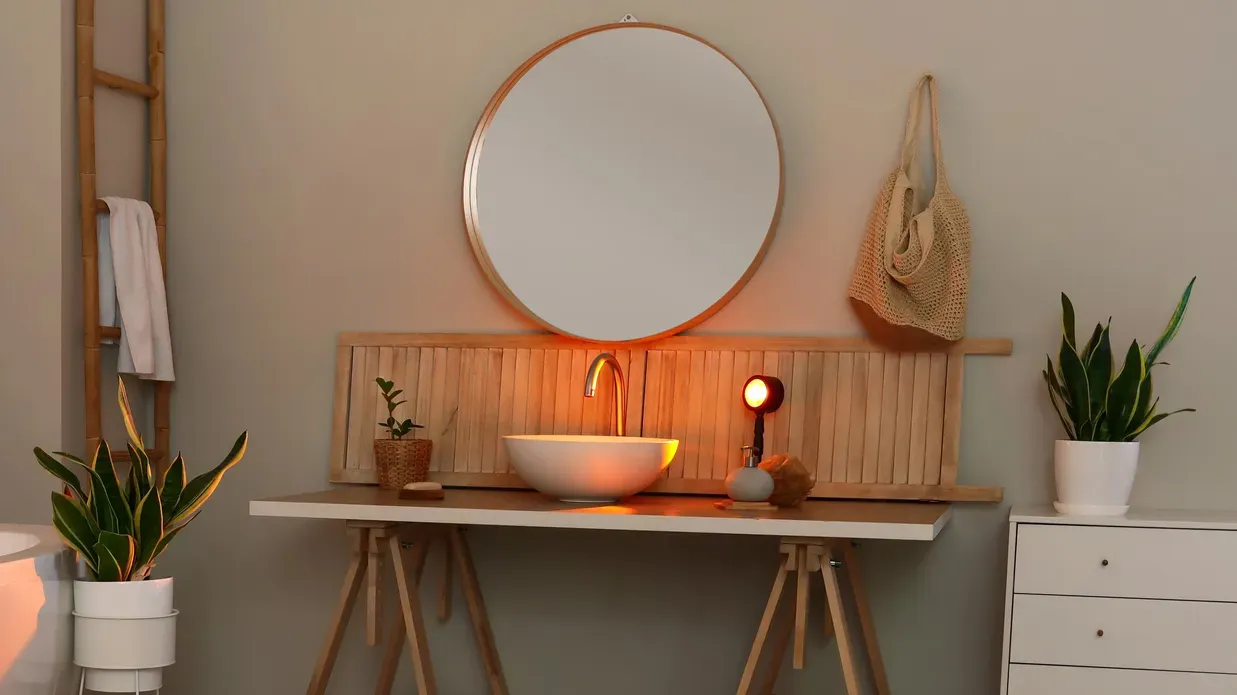 interior of modern bathroom with table sink and houseplants in