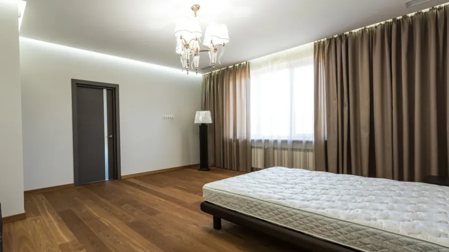 interior of modern bedroom with big window and mattress on