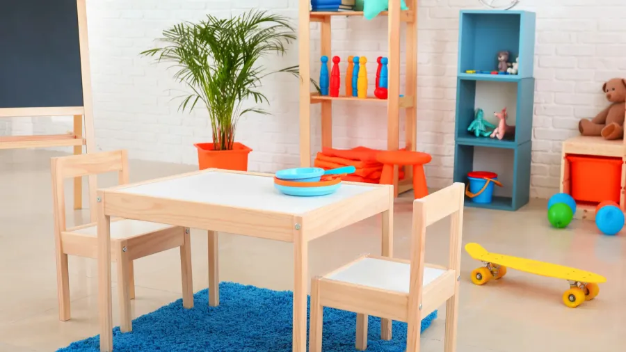 A child's playroom with a wooden table and colorful toys.