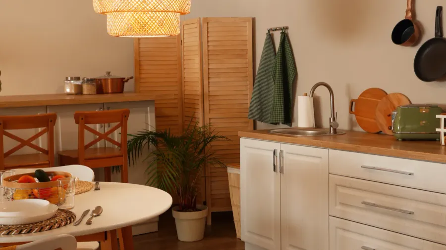 interior of modern kitchen with glowing lamps dining table and