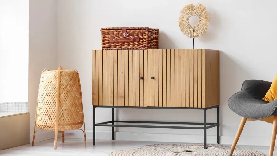 Scandinavian-style room featuring a wooden sideboard, woven basket, and decorative accessories for a warm ambiance.