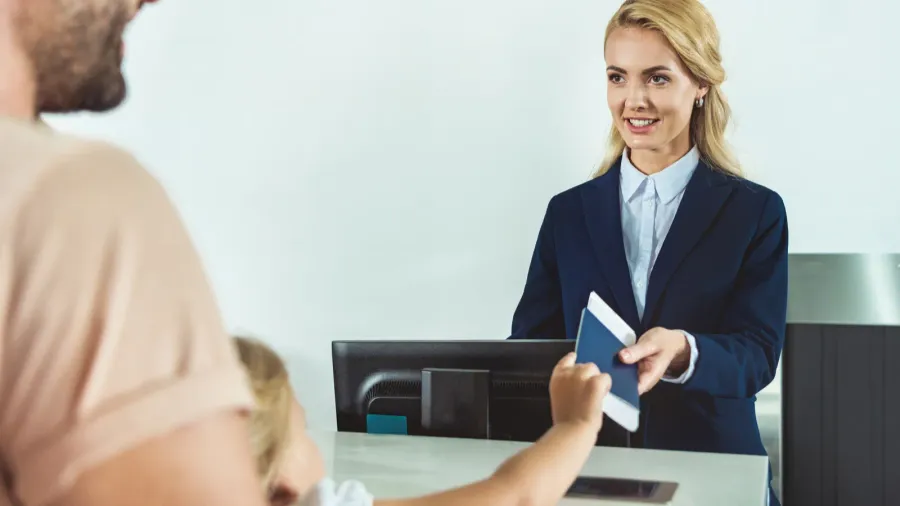 kid giving passport to staff