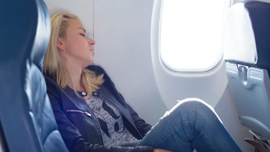 lady traveling napping on a plain