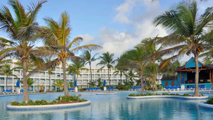 large caribbean swimmming pool with hotel in background