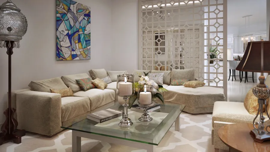 A cozy living room with a curved couch, decorative pillows, a colorful artwork hanging on the wall and an intricate patterned room divider, dividing the living room from the dining space and kitchen.