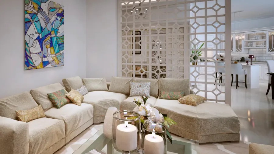A cozy living room with a curved couch, decorative pillows, a colorful artwork hanging on the wall and an intricate patterned room divider, dividing the living room from the dining space and kitchen.