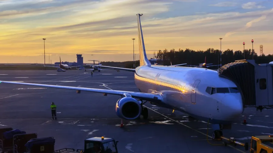 loading the plane at the airport at sunset