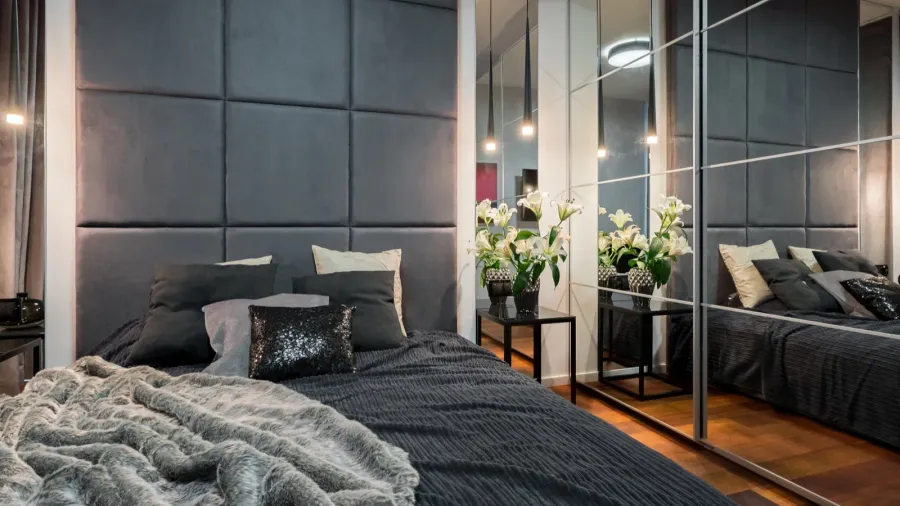 luxurious bedroom with double bed and mirrored wardrobe