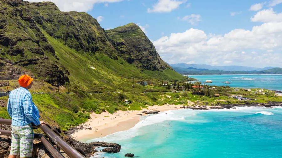 man looking at beautiful landscapes in oahu island hawaii