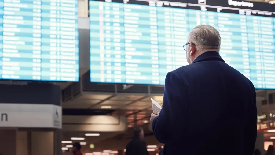 man near airline schedule