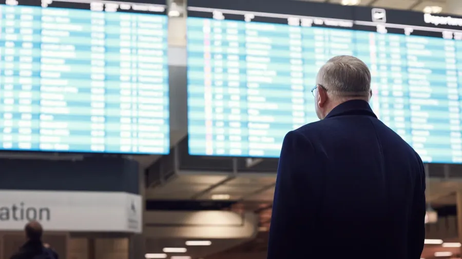 man near airline schedule