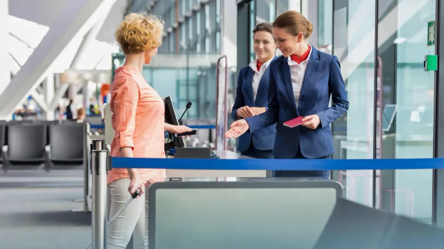mature woman on board scanning her ticket on smartphone in