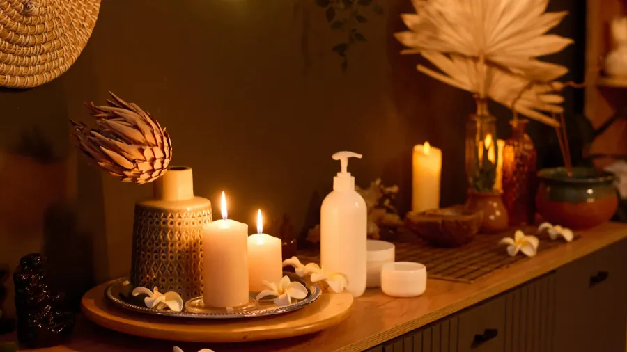 medium close up of wooden dressed with lit aroma candles