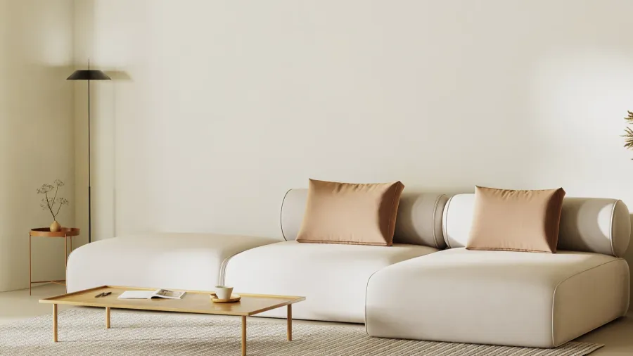 A minimalist living room with a sectional sofa with throw pillows, wooden coffee table, floor lamp, and a rug.