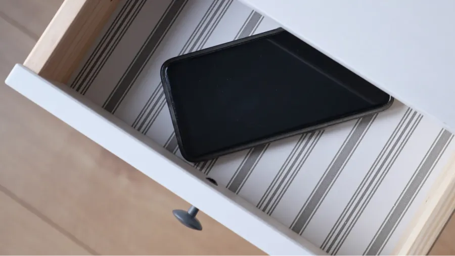 mobile phone in open drawer