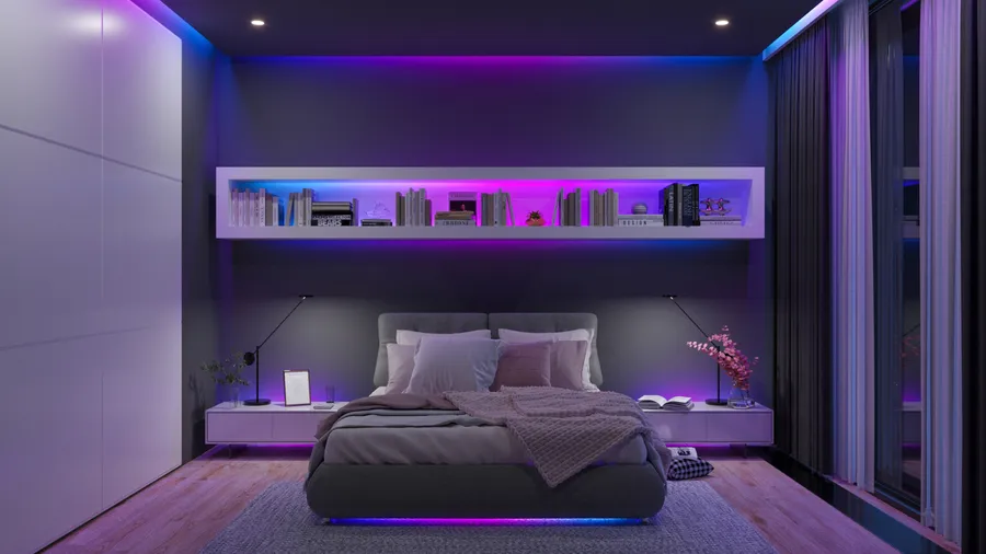 Bedroom with a bed illuminated by colorful LED lighting.