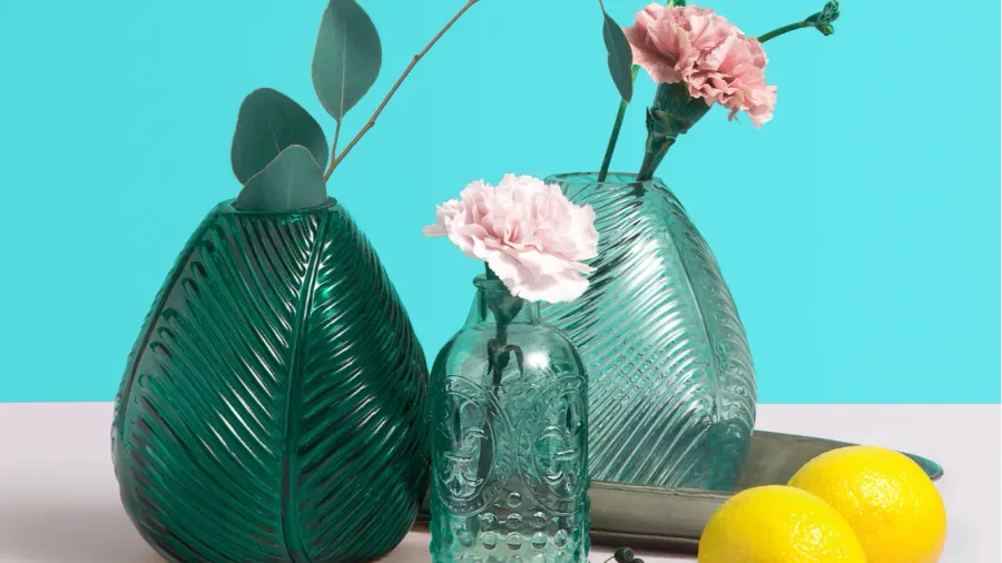 modern green glass vase with beautiful pink flowers creative composition