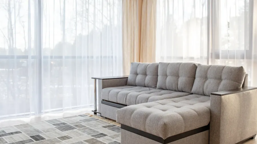 modern interior with big sofa and a large windows