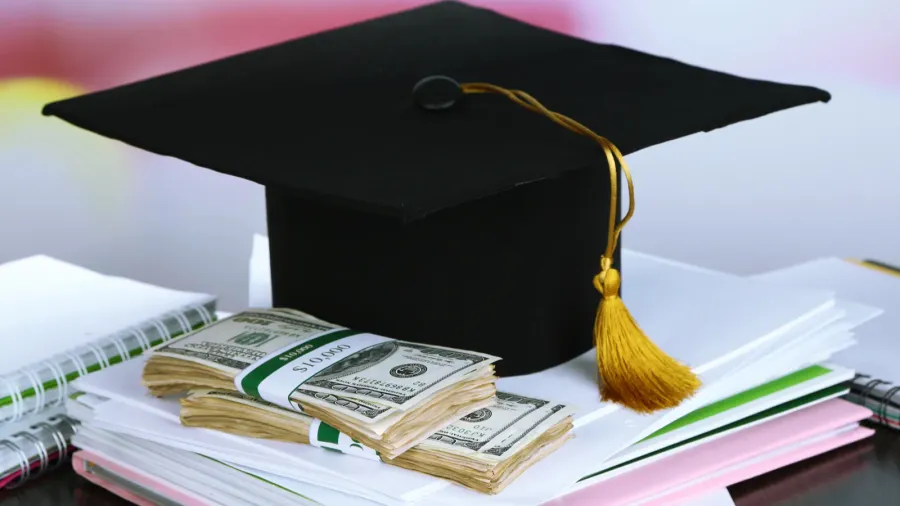 money for graduation or training on wooden table closeup