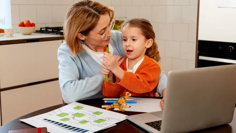 mother and daughter multitasking in a domestic setting working on