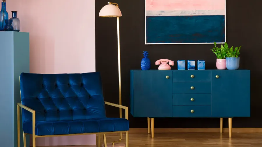 Navy blue armchair in modern living room interior with pink