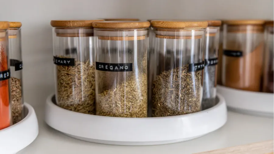 neatly organized labeled food pantry in a home kitchen with