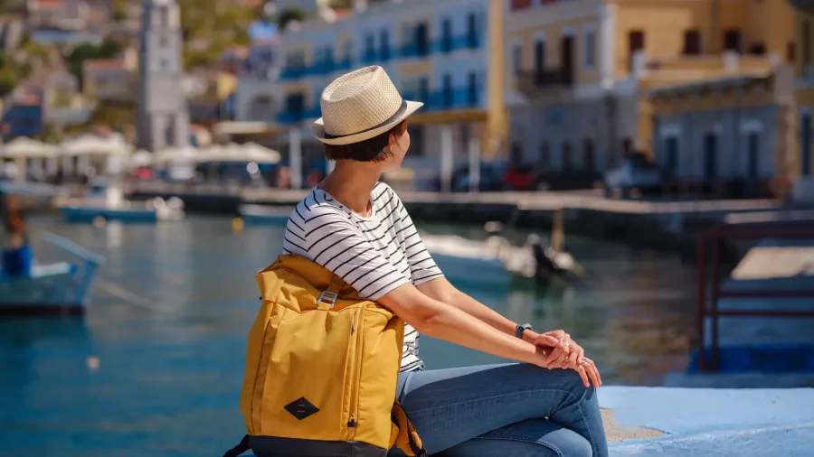 nice asian happy female with backpack enjoying her holidays on