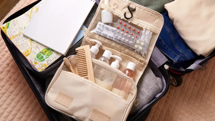 open suitcase packed with clothing toiletries and travel essentials ready
