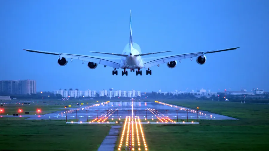 passenger plane fly up over takeoff runway from airport