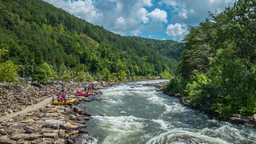 people along the ocoee river on the rocks to whitewater
