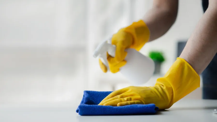 person cleaning the room cleaning staff is using cloth and