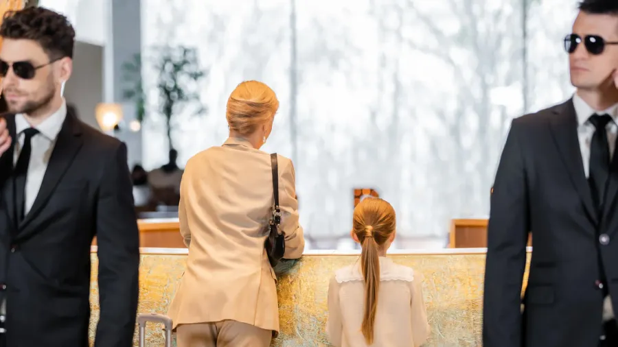 personal security lifestyle blonde mother with child standing at reception