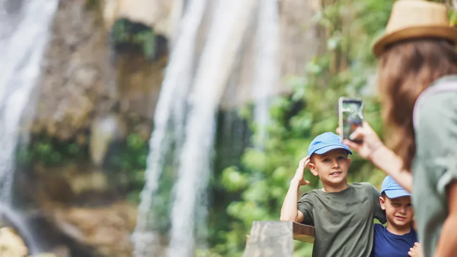 photo of mother with kids in gozalandia waterfalls high quality