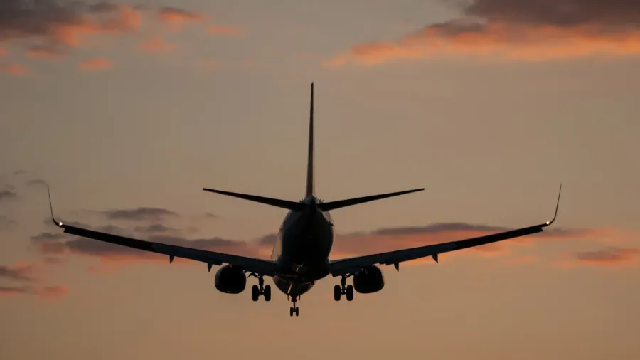 plane landing in a sunset