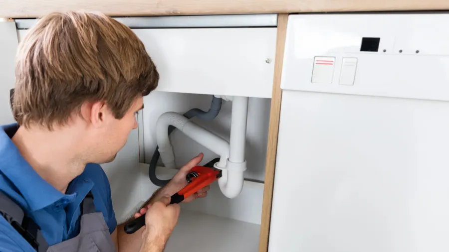 plumber fixing sink pipe
